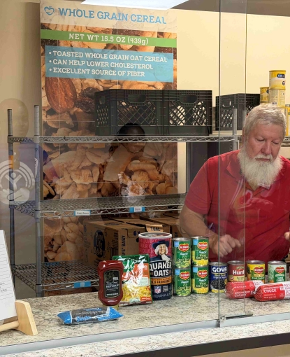 A man sorting food behind a corner.