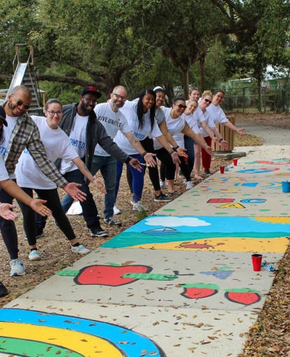 Volunteers point to painted sidewalk